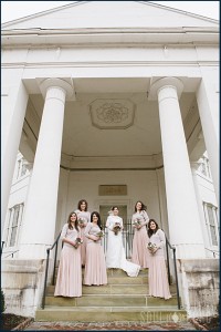 Bride and bridemaids on the stairs of the church 